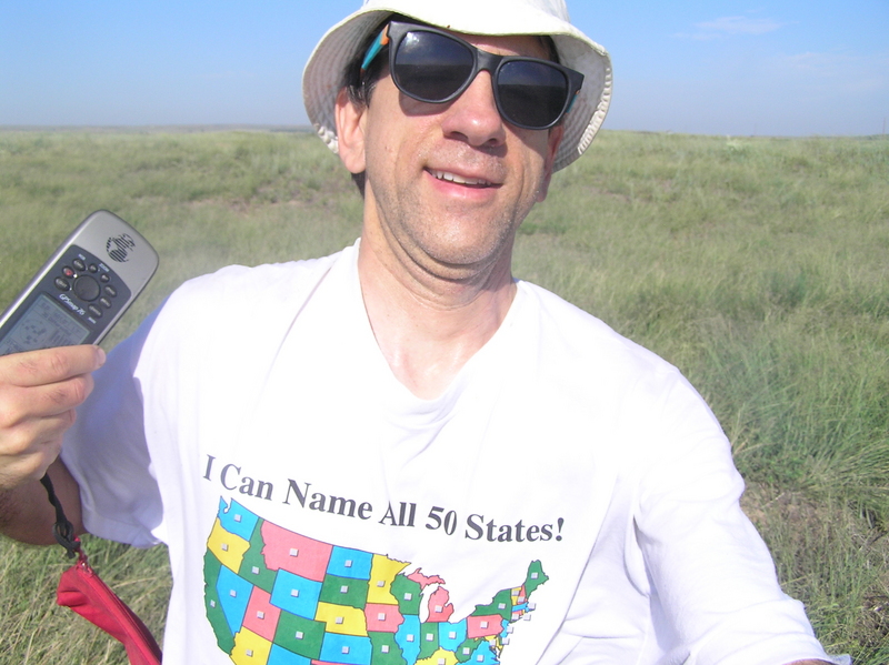 Joseph Kerski at the 37 North 100 confluence point with geographic shirt.