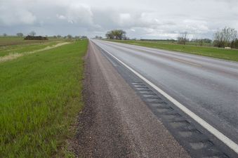 #1: The confluence point lies on the edge of this paved road.  (This is also a view to the East.)