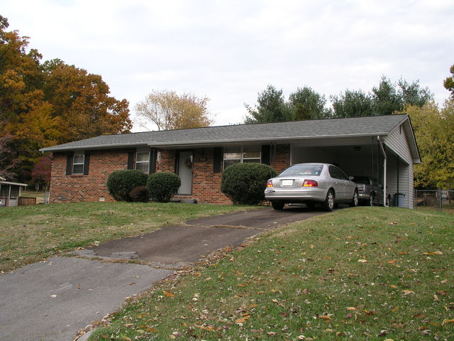 Reached through a gate to the right of the carport, the backyard of 5816 Wilkerson Road is home to 36N 084W.