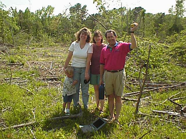 The family poses at the site