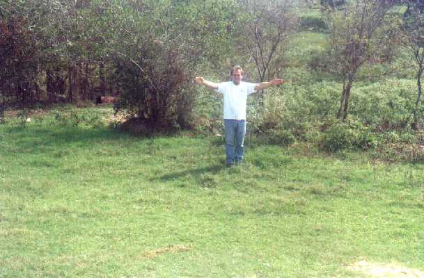 Ralph at the confluence pointing north and east.