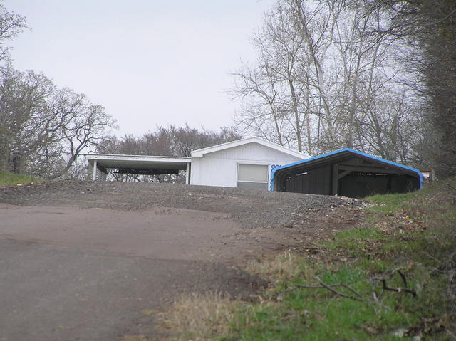 Nearest house to the confluence, looking north along the road.