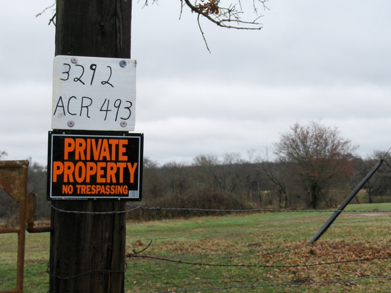 NO TRESPASSING SIGN AT THE GATE ACCESS TO CP. CP IS AT THE BACKGROUND RIGHT CORNER