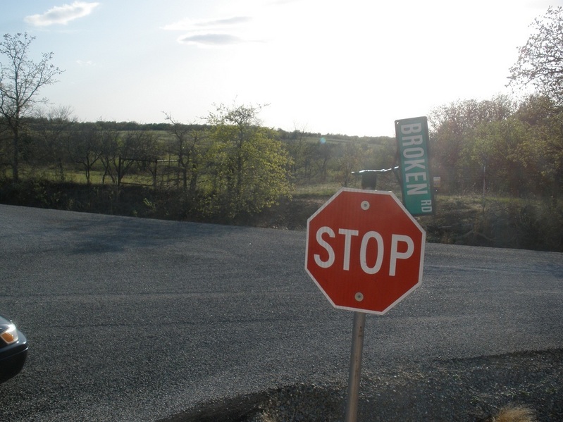 Signage at Broken Road near parking spot, looking towards confluence