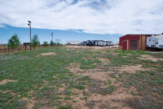 #1: The confluence point lies 60 feet from a road, just inside a RV dealership.  (This is also a view to the North.)