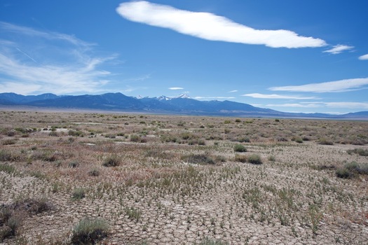 #1: The confluence point lies in a flat expanse of desert.  (This is also a view to the West, towards 13,065 ft Wheeler Peak, in Nevada’s Great Basin National Park.)