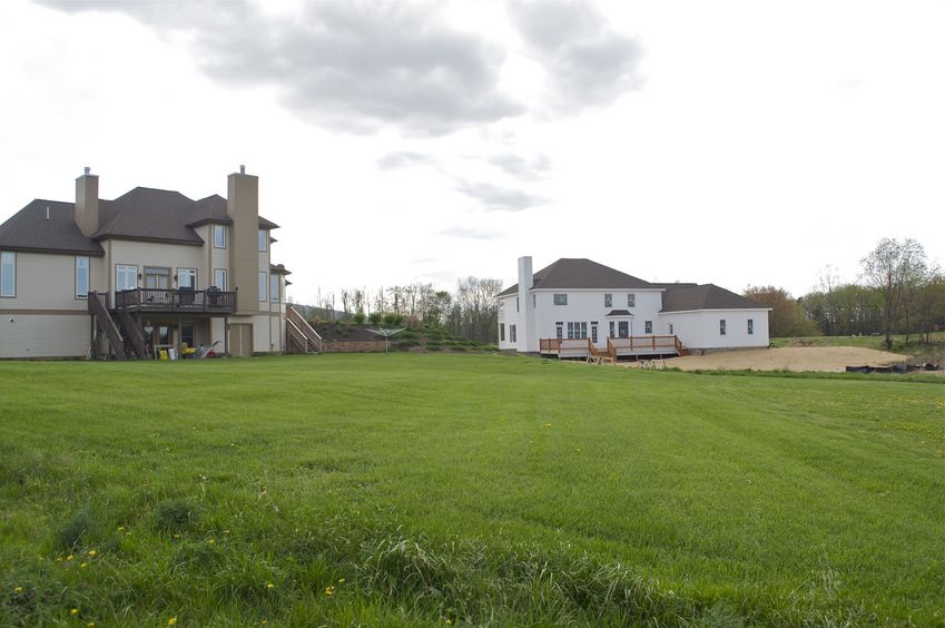 View West.  The house on the left came first; the house on the right is very recent.