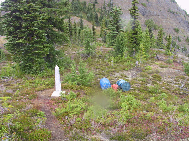 Shot of border Obelisk with fuel drums and oil beside it