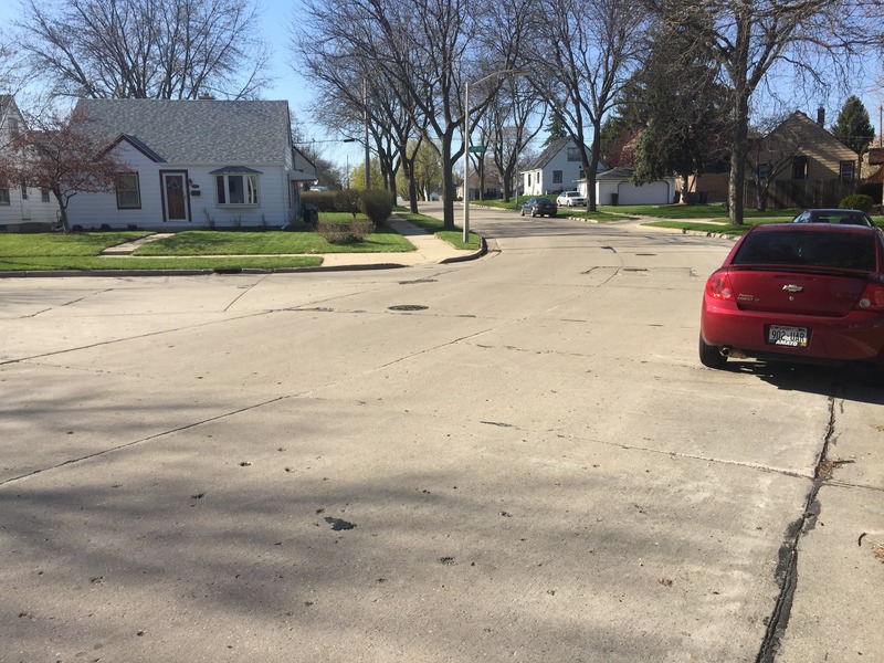 Site of 43 North 88 West, in the foreground, looking north northwest to the marker on the opposite curb.