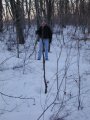 #2: Tom stands about ten feet back from the big stick upright in the snow marking our confluence estimate