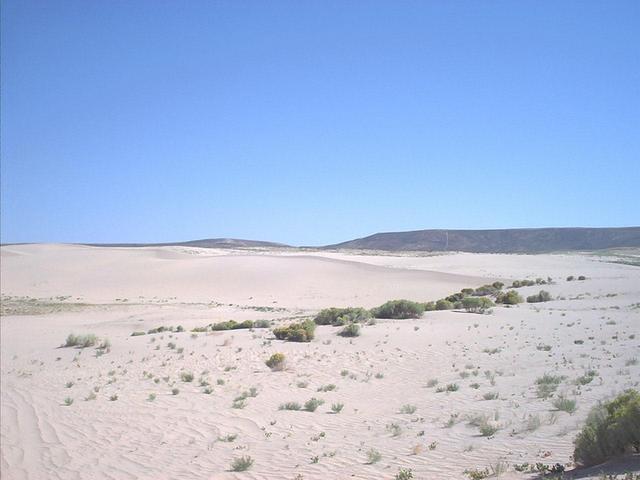 Sand dunes at the beginning.  The confluence is 7 km away through the gap in the ridge.