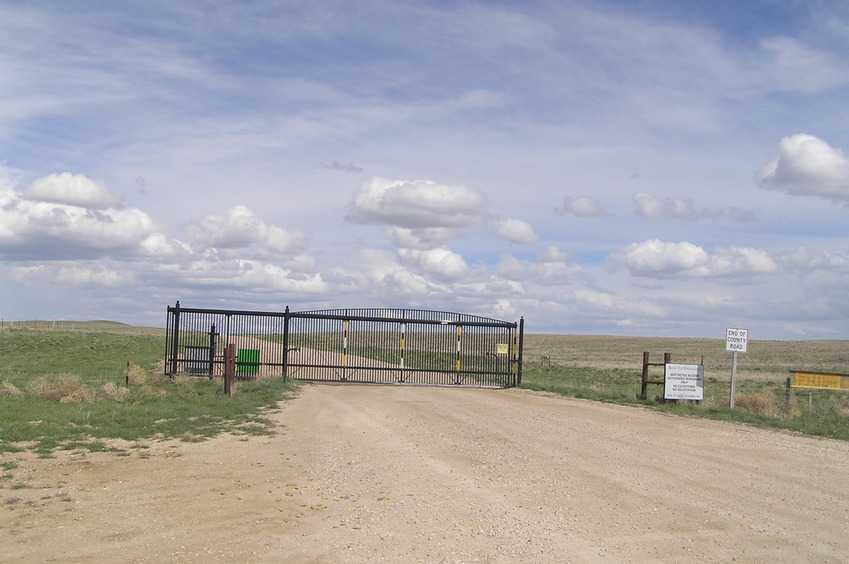 No trespassing sign and gate barring access to the area near the confluence on the approach from the west.