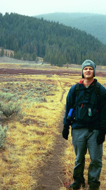 Standing along the trail (trailhead and vehicle in the distant background).