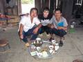 #9: Natie with 2 of the local villagers the next morning after a breakfast of rice, chicken and homemade alcohol.