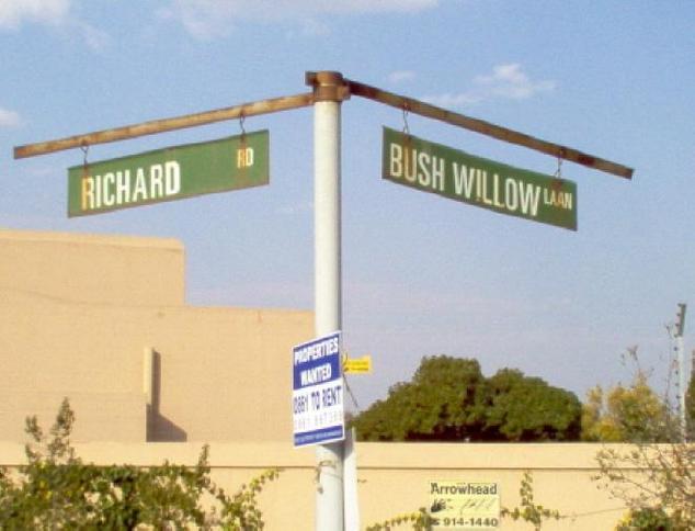 Street signs just outside entrance of complex